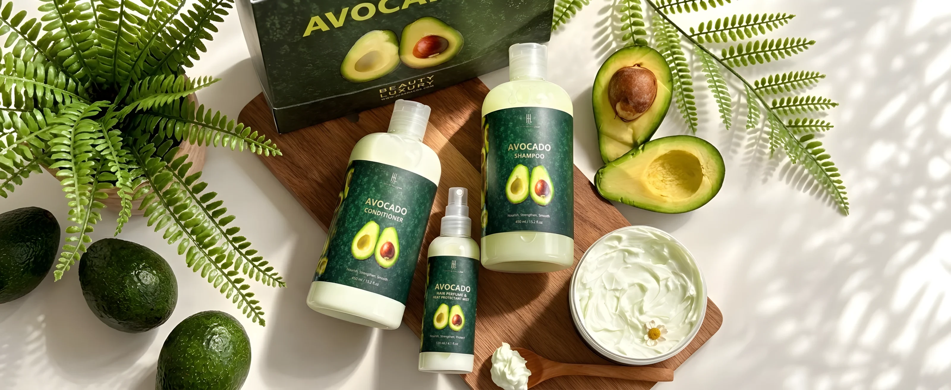 The Avocado hair set: shampoo, conditioner, hair perfume and mask in front of a green box and avocados