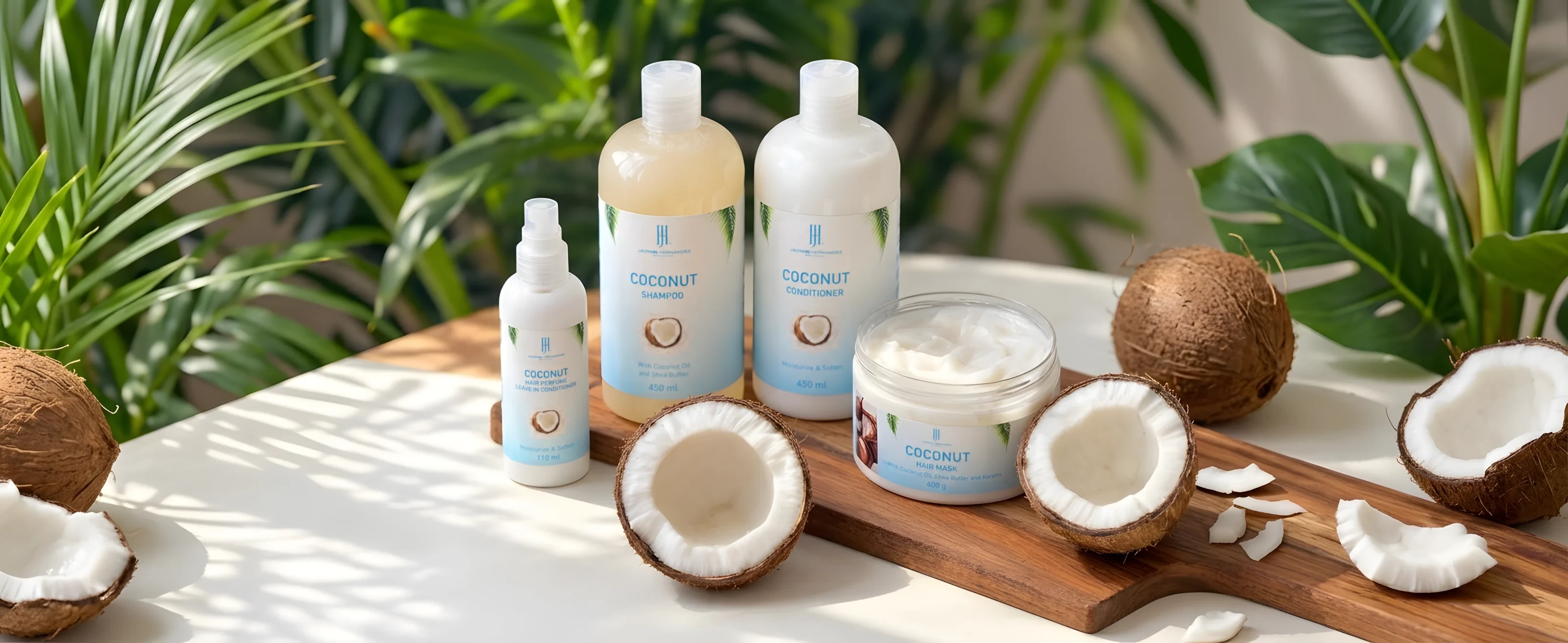 The Coconut hair set: shampoo, conditioner, mask and hair perfume with coconuts on a wooden board